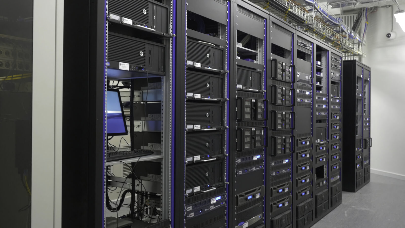Many powerful servers running in the data center server room. Many servers in a data center. Many racks with servers located in the server room. Bright display a plurality of operating equipment. Network Racks, Power & Tools